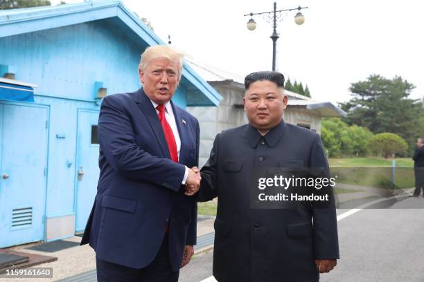 Handout photo provided by Dong-A Ilbo of North Korean leader Kim Jong Un and U.S. President Donald Trump inside the demilitarized zone separating the...