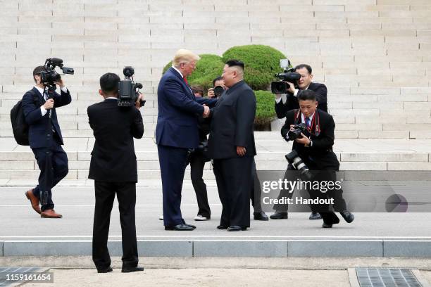 Handout photo provided by Dong-A Ilbo of North Korean leader Kim Jong Un and U.S. President Donald Trump inside the demilitarized zone separating the...