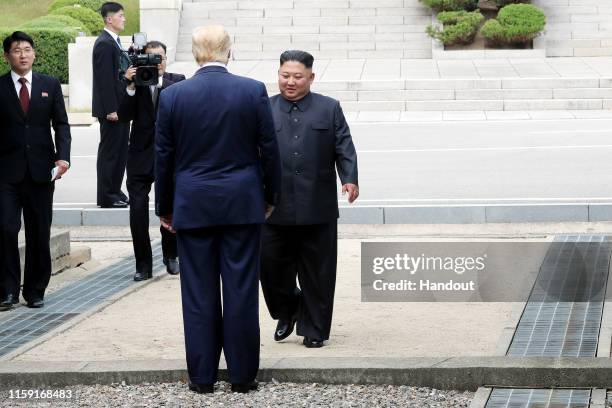 Handout photo provided by Dong-A Ilbo of North Korean leader Kim Jong Un and U.S. President Donald Trump inside the demilitarized zone separating the...