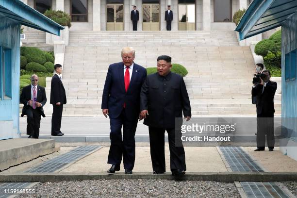 Handout photo provided by Dong-A Ilbo of North Korean leader Kim Jong Un and U.S. President Donald Trump inside the demilitarized zone separating the...