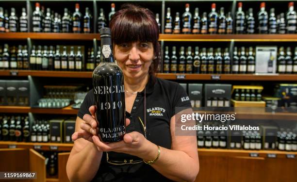 Salesperson shows a bottle of Sercial Madeira wine from 1910, that sells for 950 euros, at Blandy's Wine Lodge on June 27, 2019 in Funchal, Portugal....