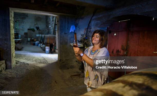 Owner Catarina Vilhena Correia serves a glass of Madeira wine produced in Fajã dos Padres winery, on June 26, 2019 in Quinta Grande, Portugal. Fajã...