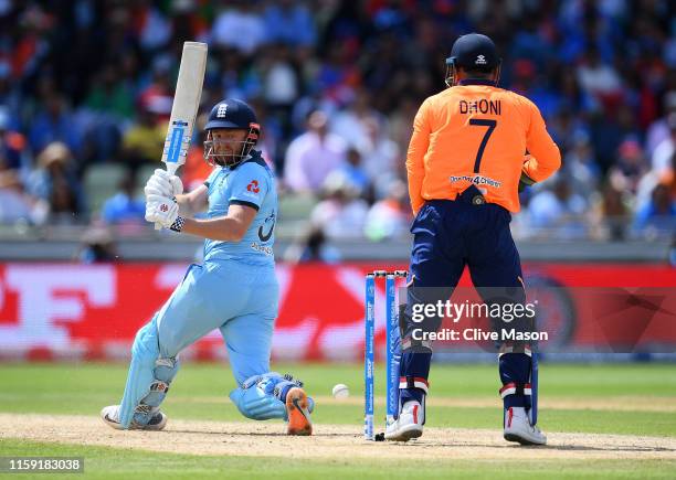 Jonny Bairstow of England on his way to a century as MS Dhoni of India looks on during the Group Stage match of the ICC Cricket World Cup 2019...