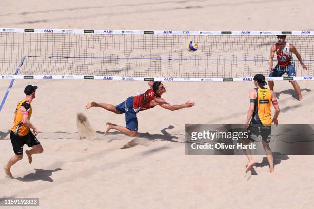 Michal Bryl of Poland dives for the ball during the match against for the ball against Philipp Arne Bergmann and Yannick Harms of Germany during day...
