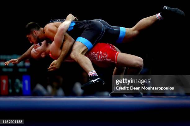 Arkadiusz Kulynycz of Poland and Radzik Kuliyeu of Belarus compete the Men's Greco-Roman -87kg Bronze Medal match or bout during Day Ten of the 2nd...