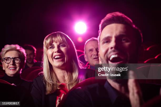 people watching comedy movie in theater - film screening stock pictures, royalty-free photos & images