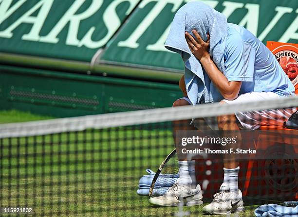 Phillip Petzchner sits on the bench after resigning in the final match against Philipp Kohlschreiber due to an injury after the Gerry Weber Open at...