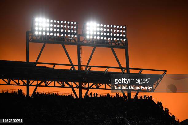Fans look on as the sun sets during the second inning of a baseball game between the San Diego Padres and the St. Louis Cardinals at Petco Park June...