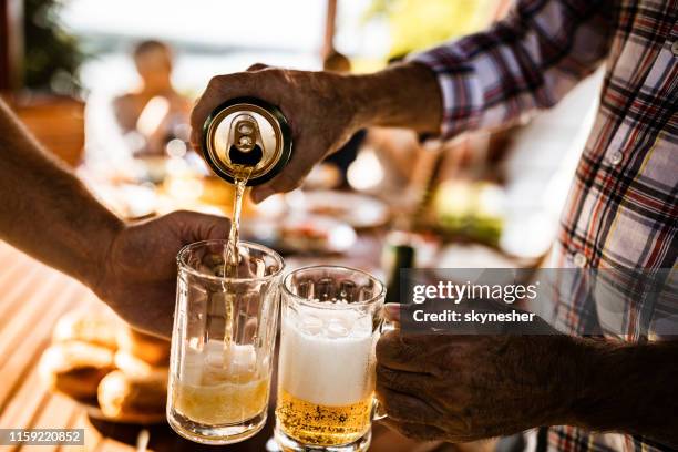 pouring beer from a can! - beer pour stock pictures, royalty-free photos & images