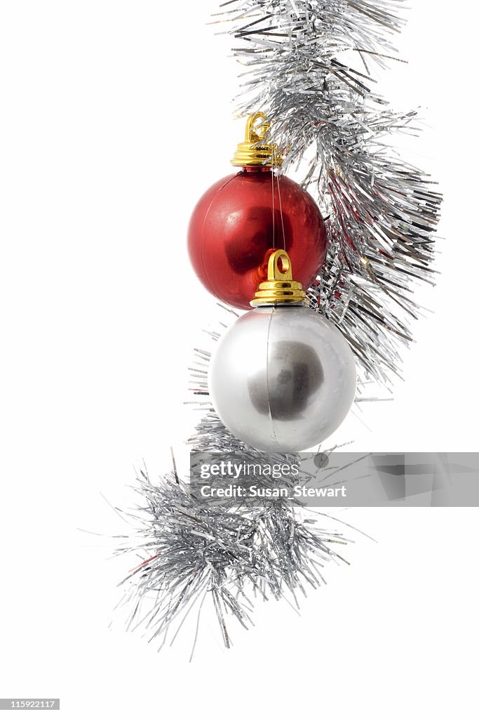 Silver and red ornament hanging from Christmas twine