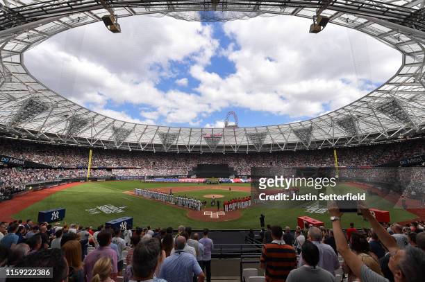 The teams stand for the national anthem during the MLB London Series game between the New York Yankees and the Boston Red Sox at London Stadium on...