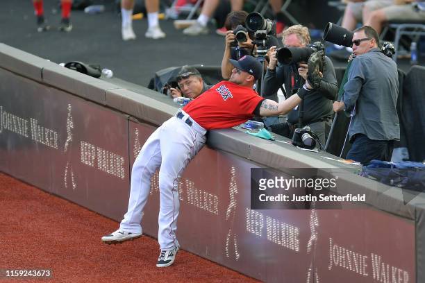 Michael Chavis of the Boston Red Sox attempts a catch a foul in front of photographers during the MLB London Series game between the New York Yankees...