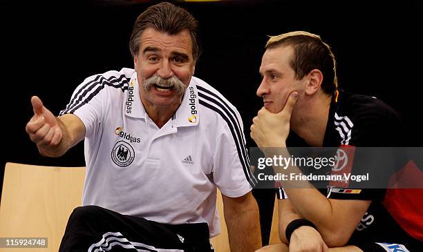 Coach Heiner Brand of Germany gives advise to Pascale Hens during the Euro 2012 qualifier match between Germany and Lithuanie on June 12, 2011 in...