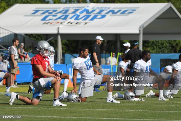 Detroit Lions TE Logan Thomas, Detroit Lions QB David Fales, and Detroit Lions S Charles Washington stretch during NFL football practice on August 1,...