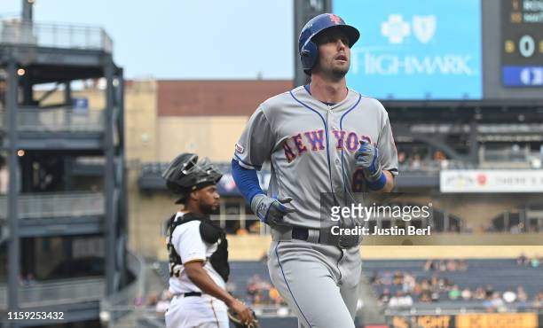 Jeff McNeil of the New York Mets comes around to score on an RBI double by Pete Alonso in the first inning during the game against the Pittsburgh...