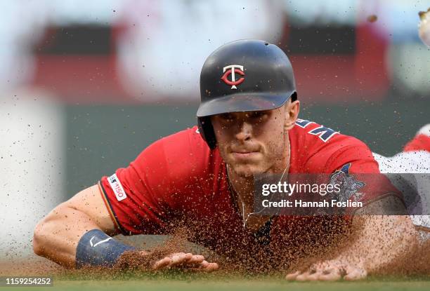 Max Kepler of the Minnesota Twins slides safely into third base against the Kansas City Royals during the first inning of the game on August 2, 2019...