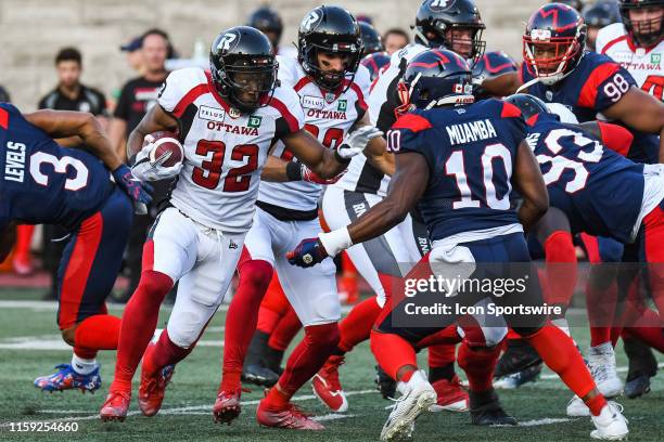 Ottawa RedBlacks Runningback John Crockett tries to avoid coverage while running with the ball during the Ottawa RedBlacks versus the Montreal...