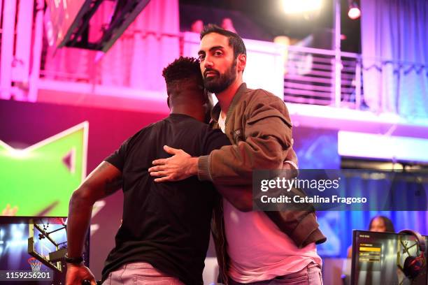 Ronnie2K of Team Ramo high-fives Jeremy Maclin of Team BearDaBeast after the game during the Celebrity Game of the NBA 2K League on August 2, 2019 at...