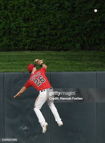 Max Kepler of the Minnesota Twins looks on as the solo home run by Hunter Dozier of the Kansas City Royals clears the center field wall during the...