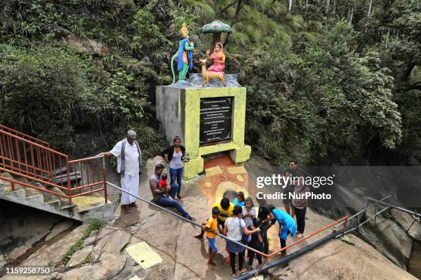 Devotees crowd around circular depressions in the rock said to be the footprints of Lord Hanuman at the Sita Amman Temple in Nuwara Eliya, Sri Lanka,...