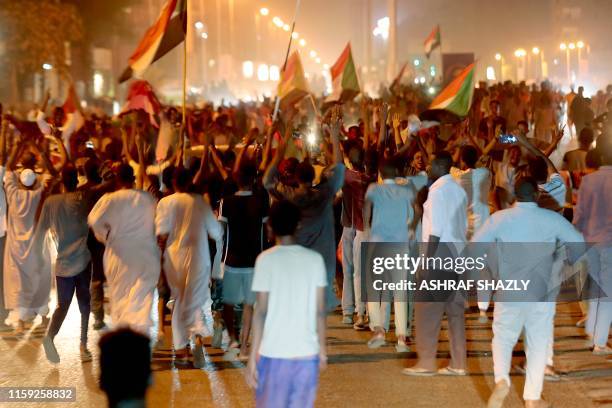 Sudanese demonstraters celebrate in Khartoum early on August 3 after Sudan's ruling generals and protest leaders reached a "full agreement" on the...