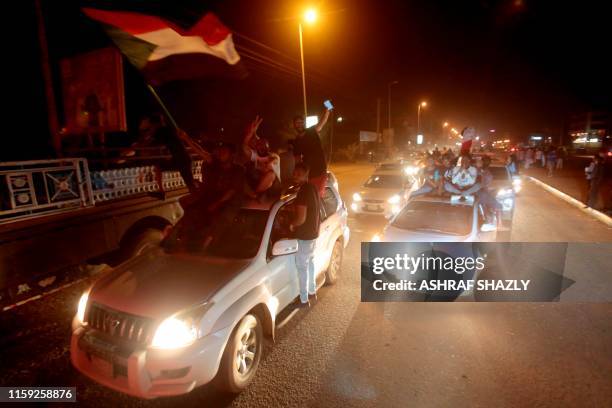 Sudanese demonstraters celebrate in Khartoum early on August 3 after Sudan's ruling generals and protest leaders reached a "full agreement" on the...