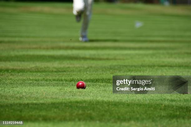 cricket ball with cricket fielder running - cricket ball stock pictures, royalty-free photos & images