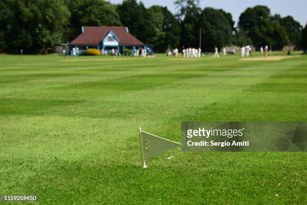 cricket boundary flag and pavilion - cricket pavilion stock pictures, royalty-free photos & images