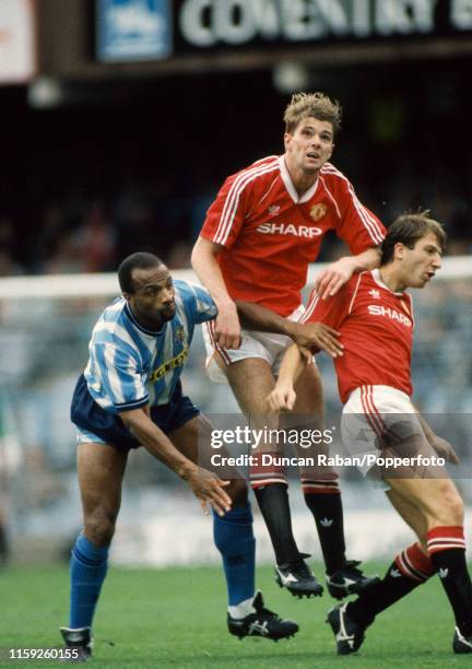 Cyrille Regis of Coventry City battles for the ball with Gary Pallister and Lee Martin of Manchester United during a Barclays League Division One...