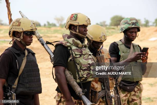 Nigerian Army soldiers stand at a base in Baga on August 2, 2019. - Intense fighting between a regional force and the Islamic State group in West...