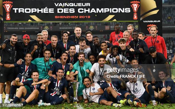 Paris Saint-Germain's players pose with the trophy as they celebrate winning the French Trophy of Champions football match between Paris...