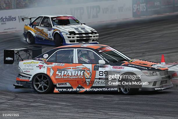 Daigo Saito of Japan driver of the Spark Motorsports Lexus Altezza is chased by Tan Tat Wei of Malaysia driver of the Goodyear Toyota Corolla AE86...