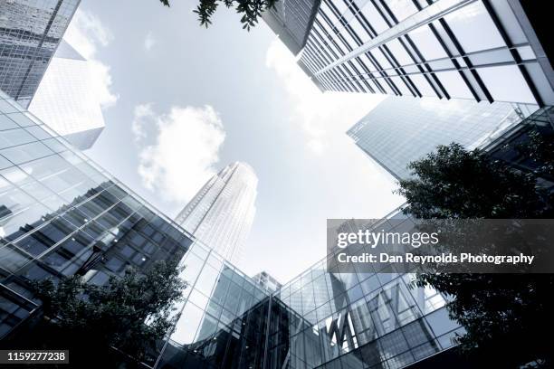 low angle view of modern buildings against sky in city - charlotte north carolina skyline stock pictures, royalty-free photos & images