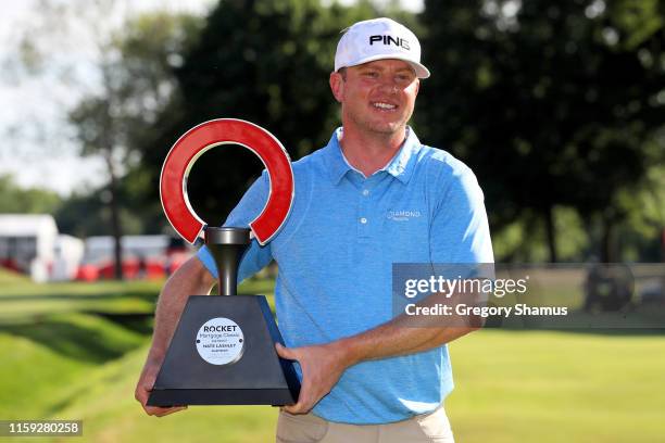 Nate Lashley celebrates with the trophy after winning the Rocket Mortgage Classic at the Detroit Country Club on June 30, 2019 in Detroit, Michigan.