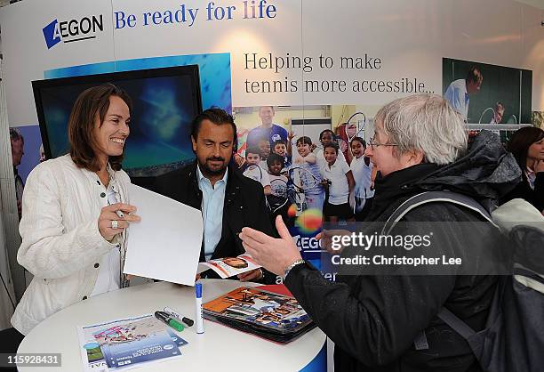 Martina Hingis and Henri Laconte, who were due to play a legends match, sign autographs for fans during 2nd Round Qualifying for the AEGON...