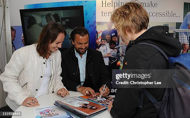 Martina Hingis and Henri Laconte, who were due to play a legends match, sign autographs for fans during 2nd Round Qualifying for the AEGON...