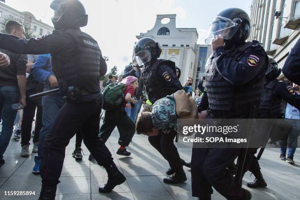 Police officers detain a man during an unsanctioned rally in the centre of Moscow, Russia. Moscow police detained more than 300 people who were...