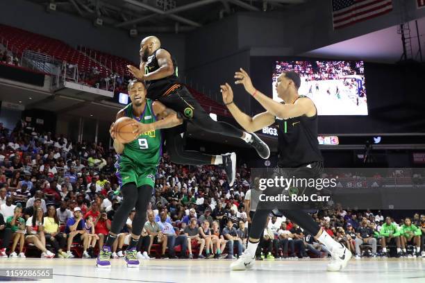 Rashard Lewis of the 3 Headed Monsters drives to the basket against Andre Owens of the Aliens during week two of the BIG3 three on three basketball...