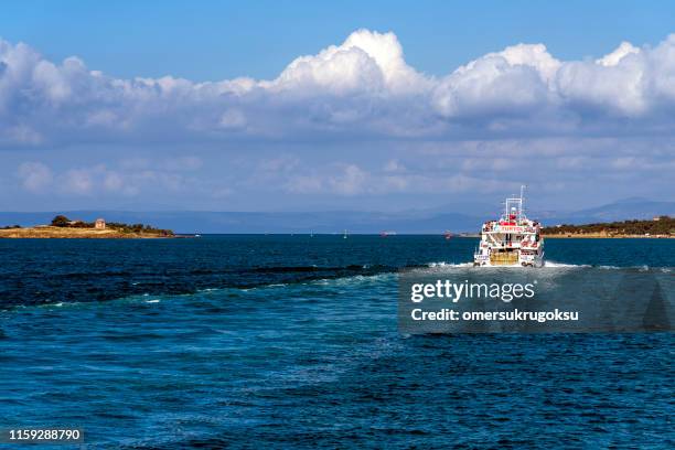 turyol which belongs to the transport company is a ferry carrying passengers and vehicles from ayvalık to mytilene in turkey. in the background is the island of lesbos, greece - funeral wake stock pictures, royalty-free photos & images