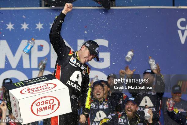 Alex Bowman, driver of the Axalta Chevrolet, celebrates in Victory Lane after winning the Monster Energy NASCAR Cup Series Camping World 400 at...