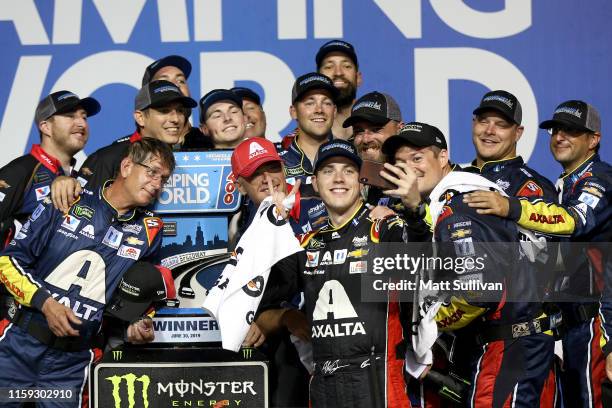 Alex Bowman, driver of the Axalta Chevrolet, takes a "selfie" with his team in Victory Lane after winning the Monster Energy NASCAR Cup Series...