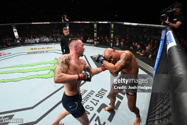 Colby Covington punches Robbie Lawler in their welterweight bout during the UFC Fight Night event at the Prudential Center on August 3, 2019 in...