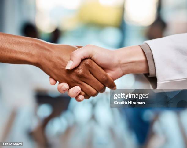 trust is at the heart of reliable healthcare - handshake closeup stock pictures, royalty-free photos & images