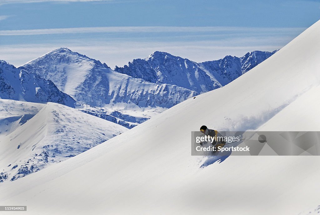 Snow Skier Making First Tracks with Mountain View