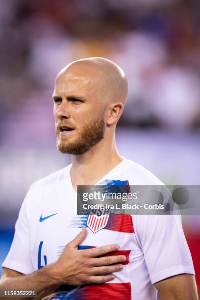 Michael Bradley of the United States holds his hands to his heart during the national anthem at the start of the CONCACAF GOLD CUP Quarterfinal match...