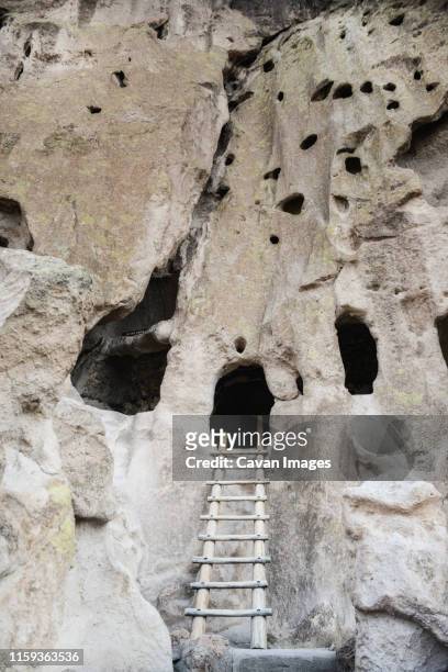 backcountry ladder leading into cliff dwelling at bandelier monument - cliff dwelling stock pictures, royalty-free photos & images