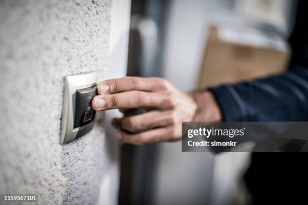 delivery man ringing doorbell - doorbell stock pictures, royalty-free photos & images