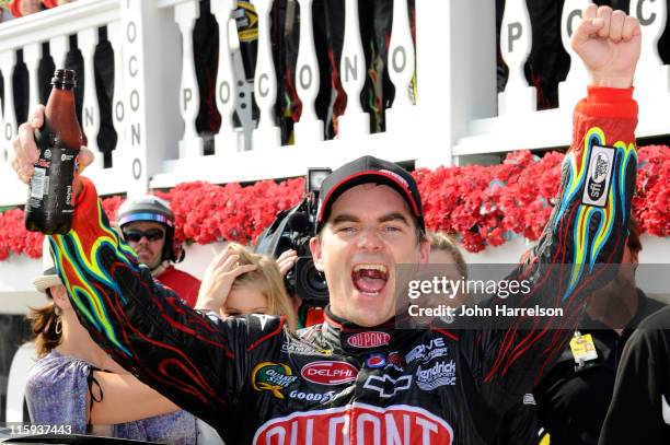 Jeff Gordon, driver of the DuPont Chevrolet, celebrates in Victory Lane after winning the NASCAR Sprint Cup Series 5-Hour Energy 500 at Pocono...