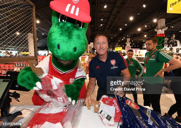 Ray Parlour helps Gunnersaurus pack kits for children at a local hospital during the Arsenal 2019-20 Adidas home kit is launch at the Armoury Shop at...