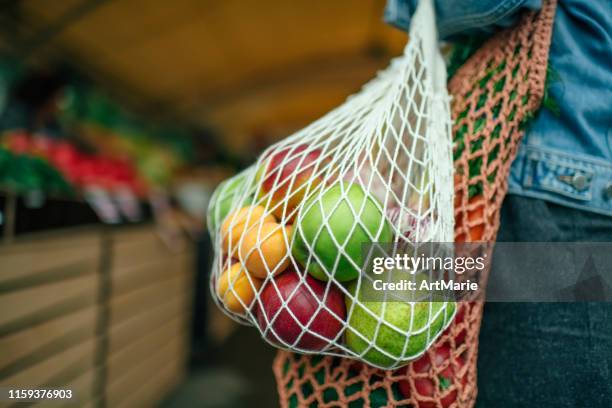 vegetables and fruit in reusable bag on a farmers market, zero waste concept - ease stock pictures, royalty-free photos & images